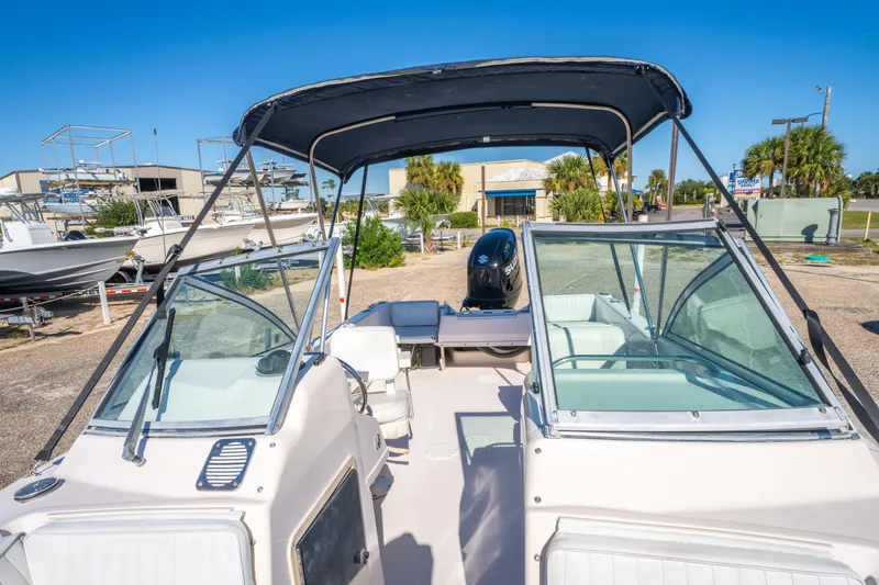 Slide: The Image of 1999 Grady-White Tournament 192 boat with canopy and seating, parked outdoors. - 19