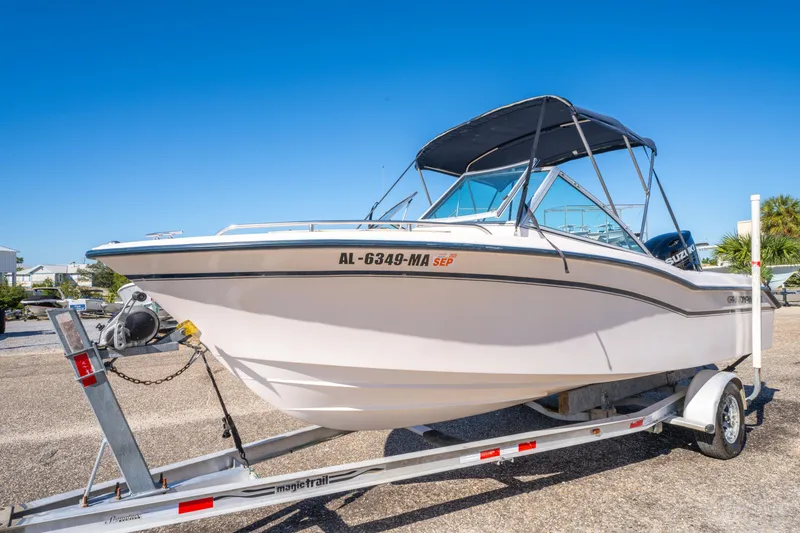 Slide: The Image of 1999 Grady-White Tournament 192 boat on trailer under clear blue sky. - 7