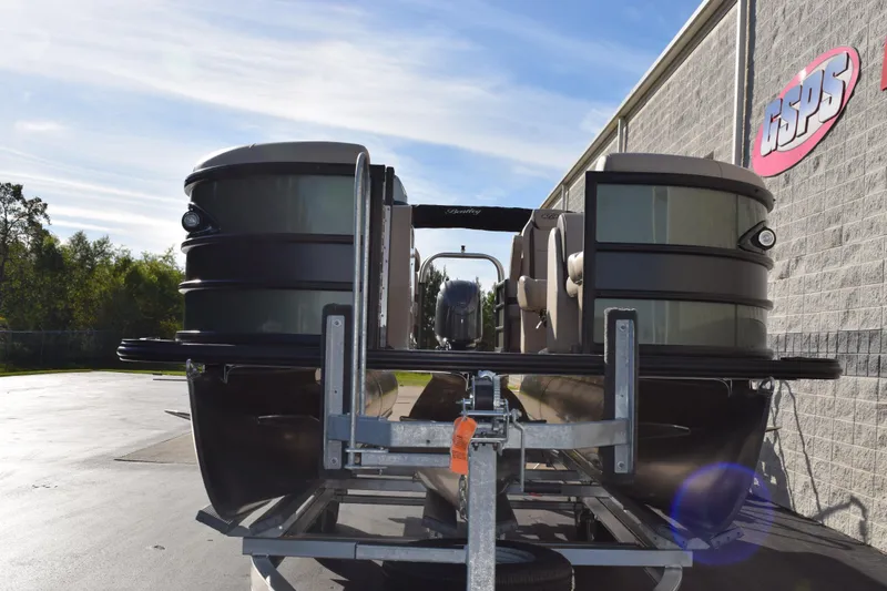 Slide: The Image of 2026 Bentley Pontoons Legacy 223 Navigator on trailer, parked outdoors. - 3