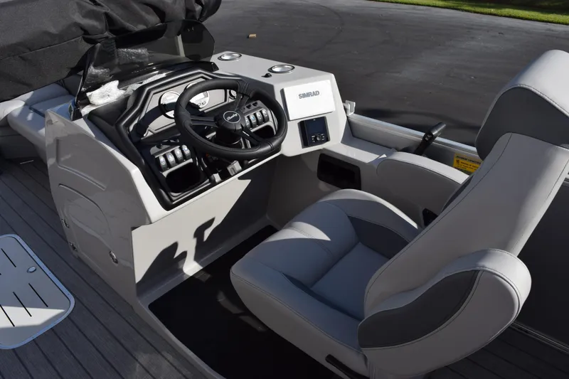Slide: The Image of 2026 Bentley Pontoons Legacy 243 Navigator helm with modern steering and controls. - 10