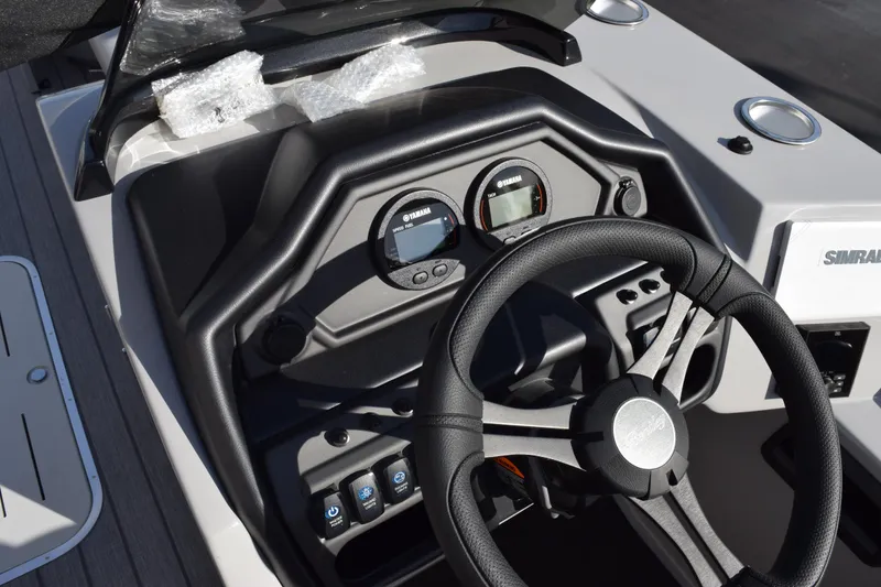 Slide: The Image of 2026 Bentley Pontoons Legacy 243 Navigator dashboard with steering wheel and instrument panel. - 16