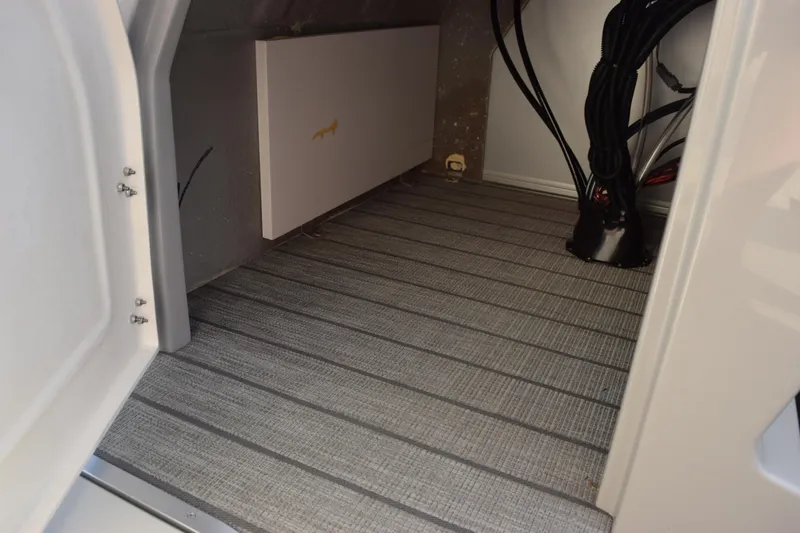 Slide: The Image of Interior view of 2026 Bentley Pontoons Legacy 243 Navigator, showcasing wiring and flooring. - 19