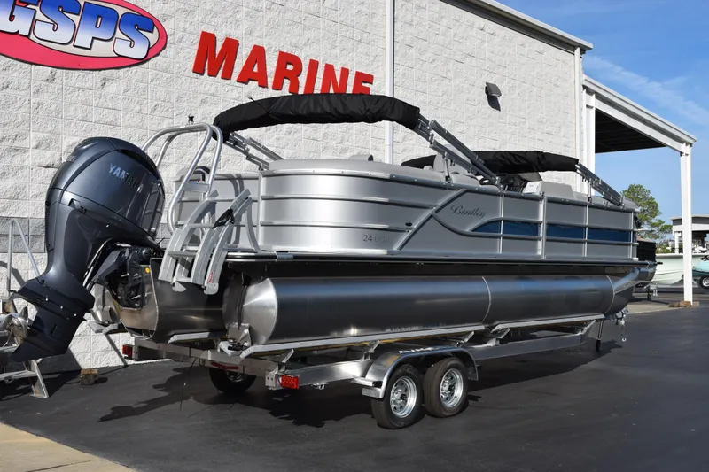 Slide: The Image of 2026 Bentley Pontoons Legacy 243 Navigator at marine dealership, featuring Yamaha outboard motor. - 4