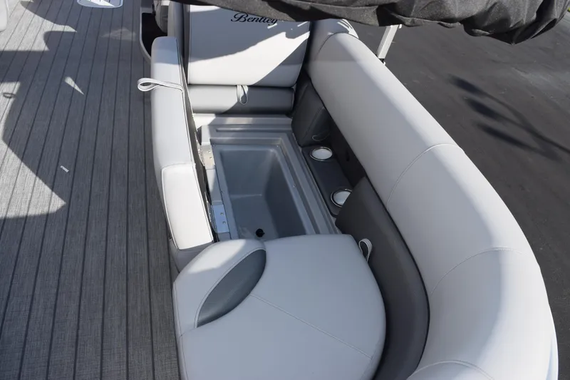 Slide: The Image of 2026 Bentley Pontoons Legacy 243 Navigator interior seating with storage and cup holders. - 8