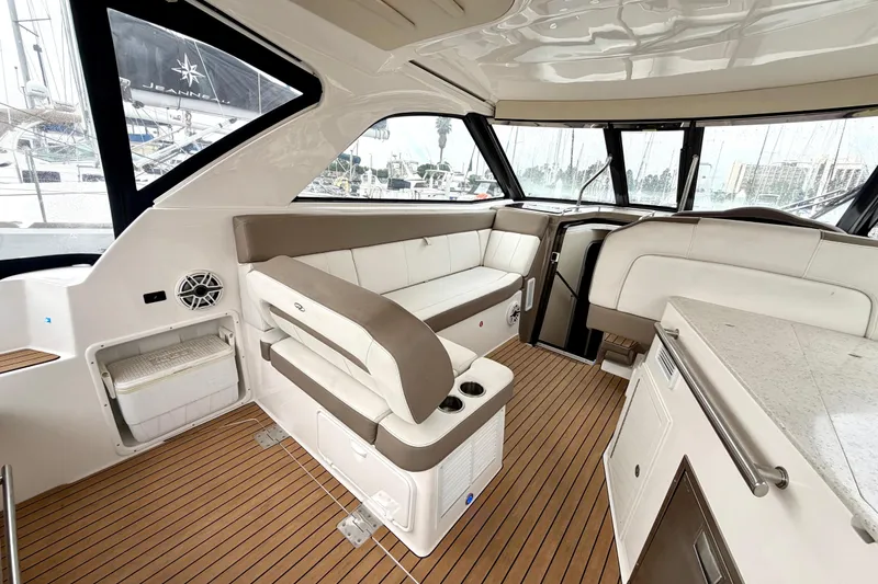 Slide: The Image of 2017 Regal 35 Sport Coupe interior with beige seating and wood flooring. - 21