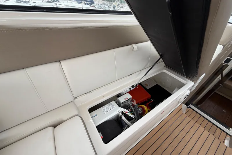 Slide: The Image of 2017 Regal 35 Sport Coupe interior storage compartment with open seat revealing equipment. - 22