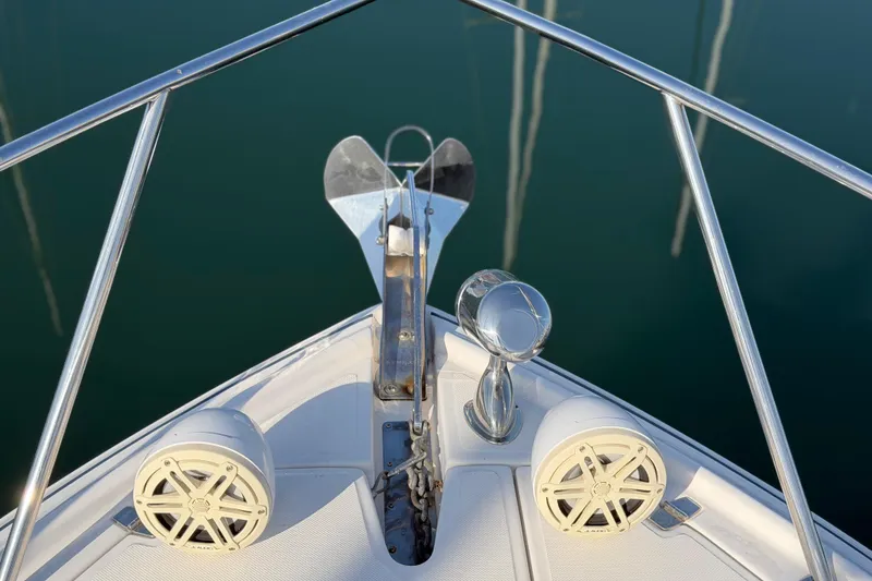 Slide: The Image of Bow of 2017 Regal 35 Sport Coupe with anchor and speakers, on calm water. - 34