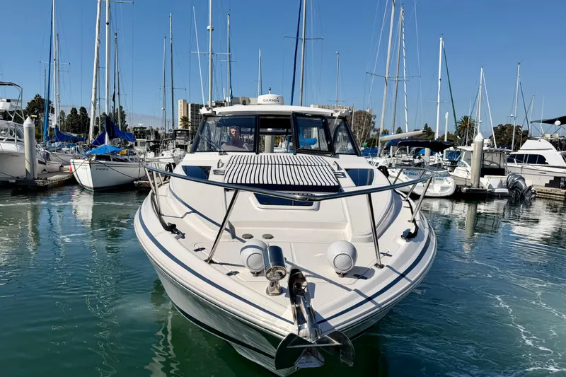 Slide: The Image of 2017 Regal 35 Sport Coupe docked in a marina, surrounded by sailboats. - 37