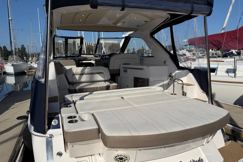 Slide: The Image of 2017 Regal 35 Sport Coupe yacht with spacious deck and luxurious seating at marina. - 39