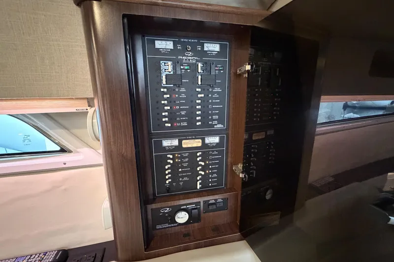 Slide: The Image of 2017 Regal 35 Sport Coupe electrical panel with wood finish and control switches. - 9