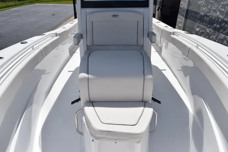 Slide: The Image of 2026 Sea Hunt Gamefish 27 Coffin Box boat interior with white seating and sleek design. - 12