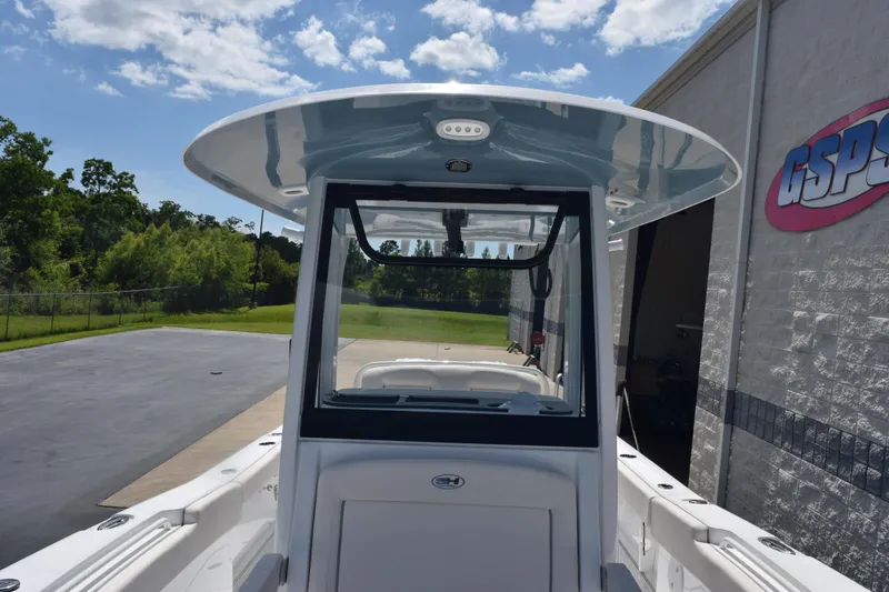 Slide: The Image of 2026 Sea Hunt Gamefish 27 Coffin Box boat at dealership, sunny day. - 13