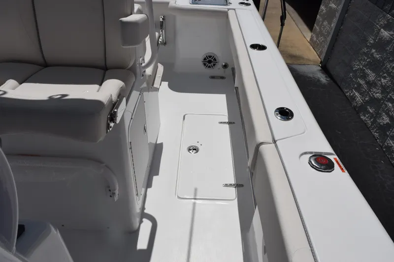 Slide: The Image of Interior of 2026 Sea Hunt Gamefish 27 Coffin Box boat, featuring seating and storage. - 14