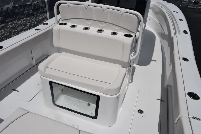 Slide: The Image of 2026 Sea Hunt Gamefish 27 Coffin Box boat interior with cushioned seating and rod holders. - 7