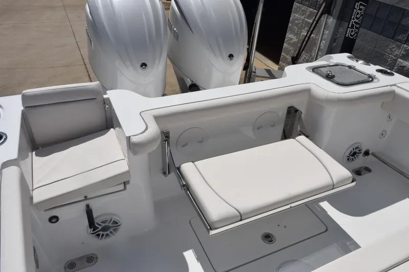 Slide: The Image of 2026 Sea Hunt Gamefish 27 Coffin Box boat interior with seating and dual engines. - 8