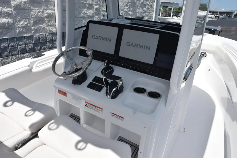Slide: The Image of 2026 Sea Hunt Gamefish 27 Coffin Box boat dashboard with Garmin displays and steering wheel. - 9