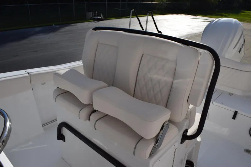 Slide: The Image of 2026 Sea Hunt Ultra 255 SE boat seating with cushioned armrests and diamond-patterned upholstery. - 10