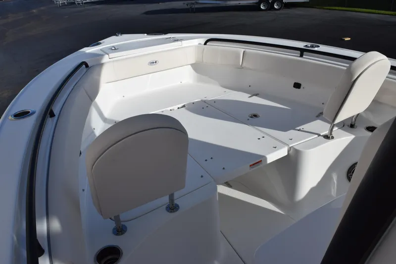 Slide: The Image of 2026 Sea Hunt Ultra 255 SE boat interior with white seating and deck. - 11