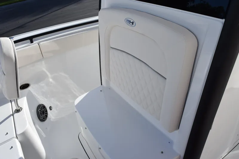 Slide: The Image of 2026 Sea Hunt Ultra 255 SE boat interior with cushioned seating and speaker detail. - 12