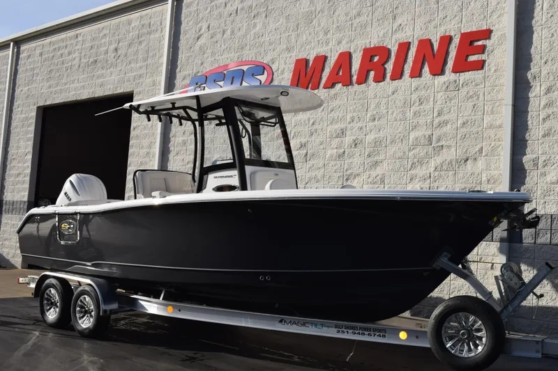 Slide: The Image of 2026 Sea Hunt Ultra 255 SE boat on trailer outside marine dealership. - 2