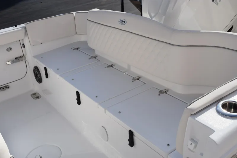 Slide: The Image of 2026 Sea Hunt Ultra 255 SE boat interior with white seating and storage compartments. - 7