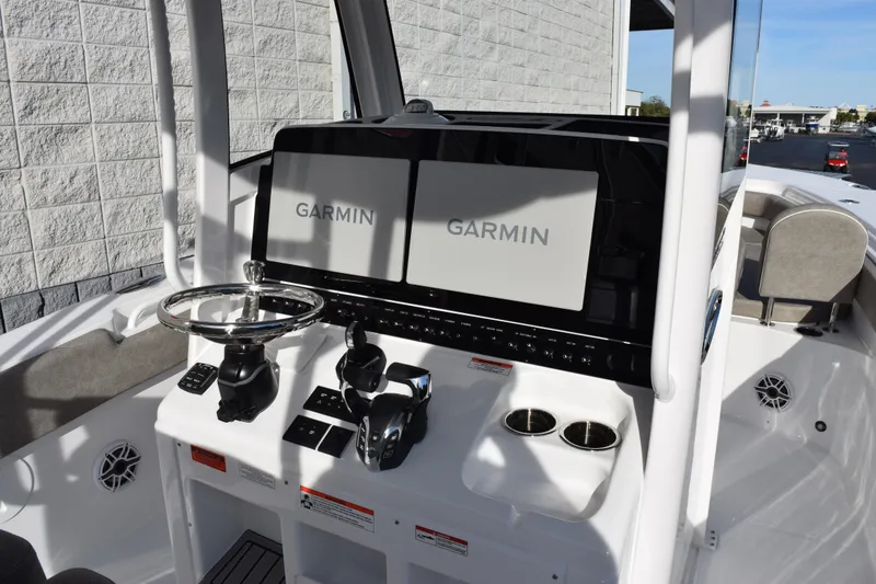 Slide: The Image of 2026 Sea Hunt Ultra 285 SE boat dashboard with Garmin navigation displays. - 10