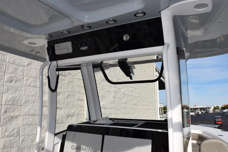 Slide: The Image of 2026 Sea Hunt Ultra 285 SE boat console with Garmin electronics and overhead storage. - 11
