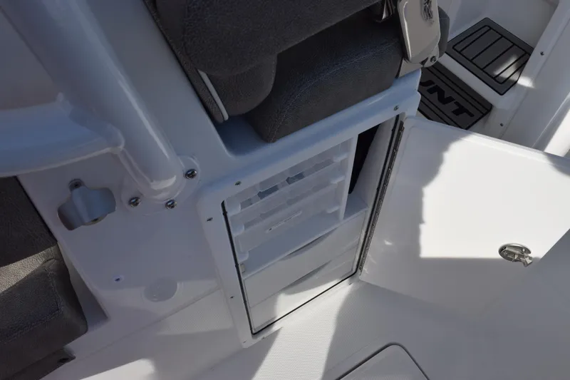 Slide: The Image of 2026 Sea Hunt Ultra 285 SE boat interior storage compartment with open door. - 17