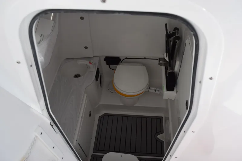 Slide: The Image of 2026 Sea Hunt Ultra 285 SE boat interior bathroom with toilet and sink. - 22