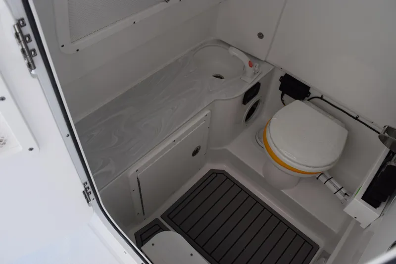 Slide: The Image of 2026 Sea Hunt Ultra 285 SE boat bathroom with toilet and sink. - 23