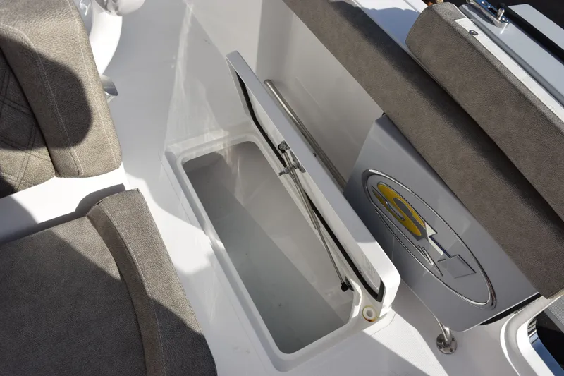 Slide: The Image of Open storage compartment on 2026 Sea Hunt Ultra 285 SE boat with cushioned seating. - 26
