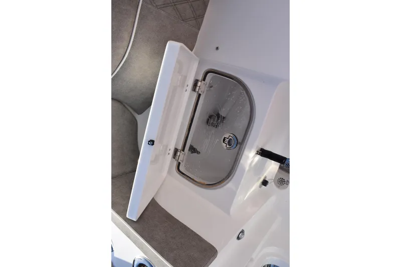 Slide: The Image of 2026 Sea Hunt Ultra 285 SE boat storage compartment with open lid. - 28