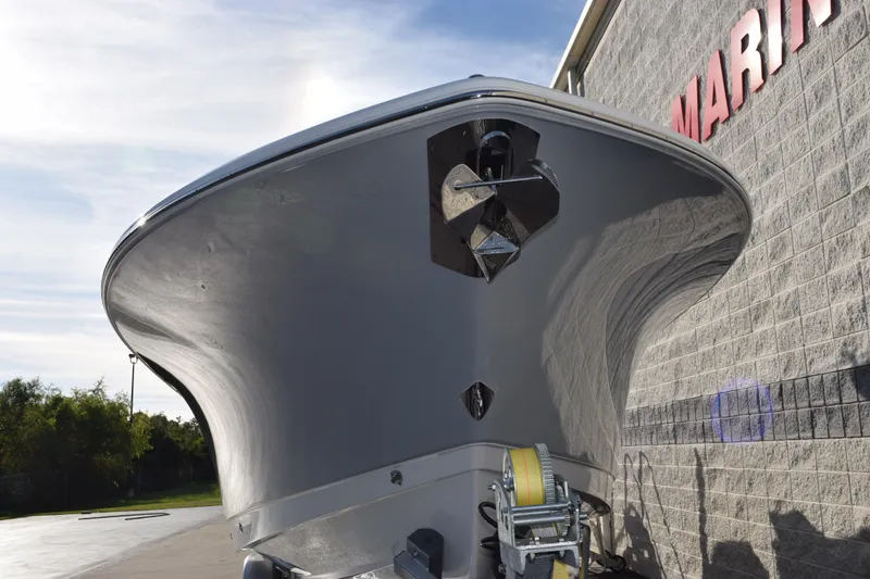 Slide: The Image of 2026 Sea Hunt Ultra 285 SE boat, front view, parked near a building. - 3