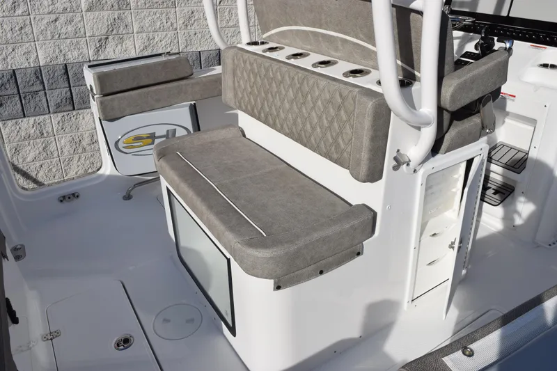 Slide: The Image of 2026 Sea Hunt Ultra 285 SE boat interior with cushioned seating and storage compartments. - 8