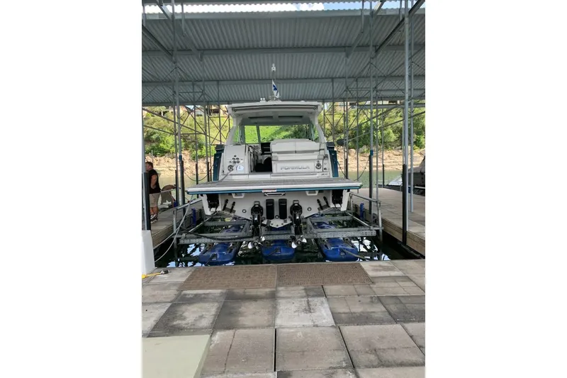 Slide: The Image of 2021 Formula 380 Super Sport Crossover I/O docked in a covered marina. - 11