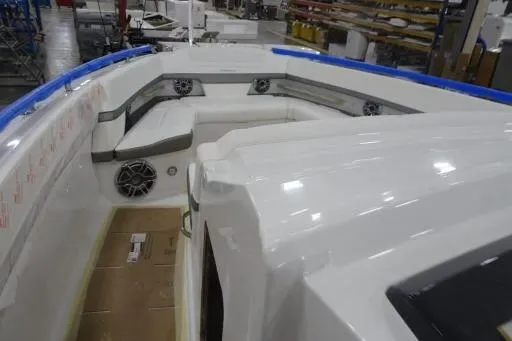 Slide: The Image of 2021 Formula 380 Super Sport Crossover I/O boat interior with white seating and speakers. - 3