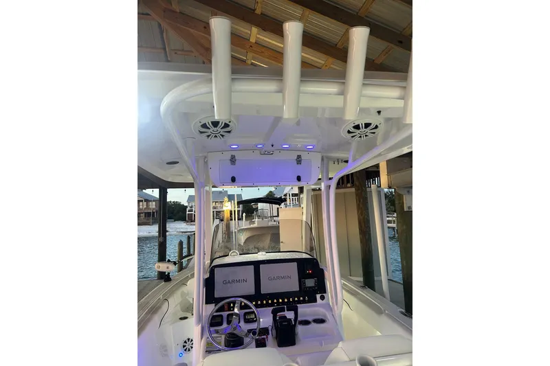Slide: The Image of 2015 Sea Hunt Gamefish 25 boat interior with Garmin navigation system and rod holders. - 12
