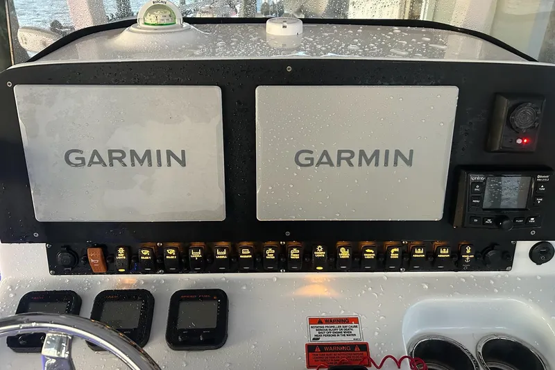 Slide: The Image of Control panel of a 2015 Sea Hunt Gamefish 25 with Garmin displays. - 21