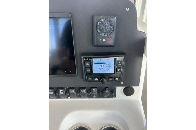 Slide: The Image of Control panel of a 2015 Sea Hunt Gamefish 25 boat with radio and display. - 23