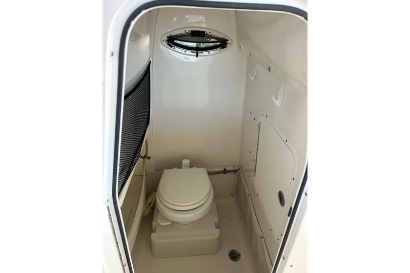 Slide: The Image of 2015 Sea Hunt Gamefish 25 boat interior with compact marine toilet. - 27