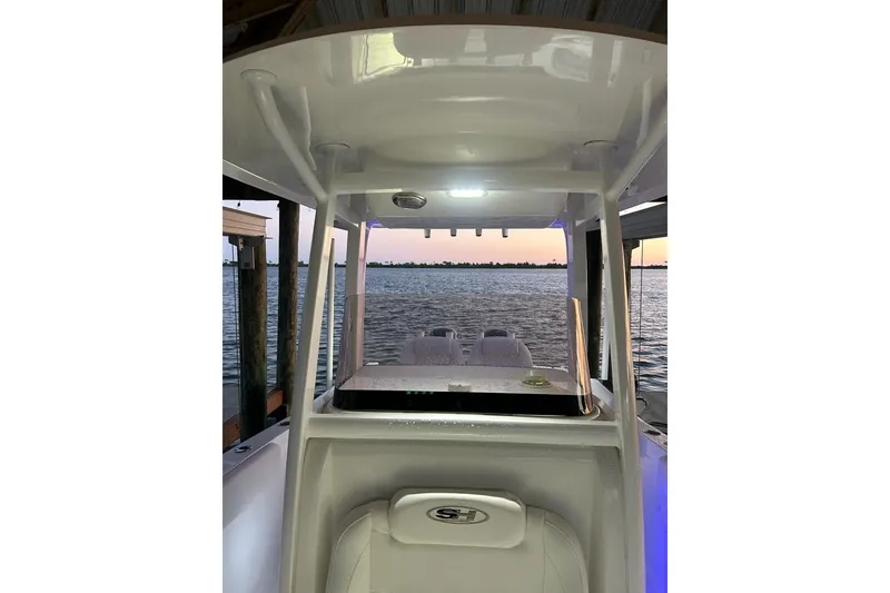 Slide: The Image of 2015 Sea Hunt Gamefish 25 boat interior with sunset view over the water. - 28