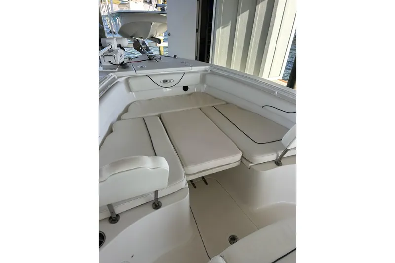 Slide: The Image of 2015 Sea Hunt Gamefish 25 boat interior with cushioned seating and storage compartments. - 30