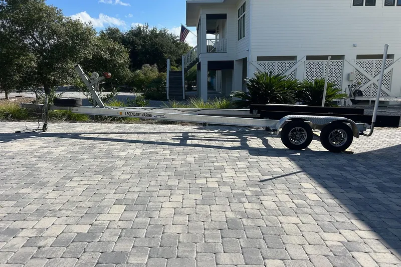 Slide: The Image of Boat trailer for 2015 Sea Hunt Gamefish 25 on paved driveway. - 33