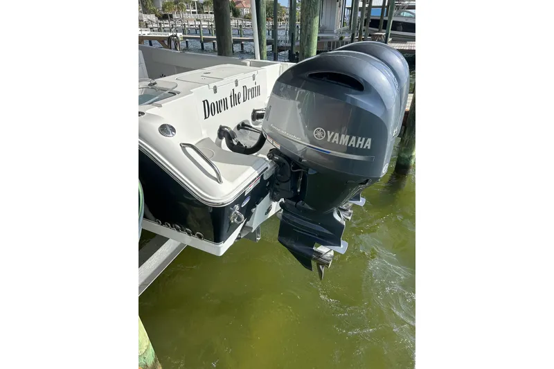 Slide: The Image of 2015 Sea Hunt Gamefish 25 with Yamaha outboard motors docked at marina. - 6