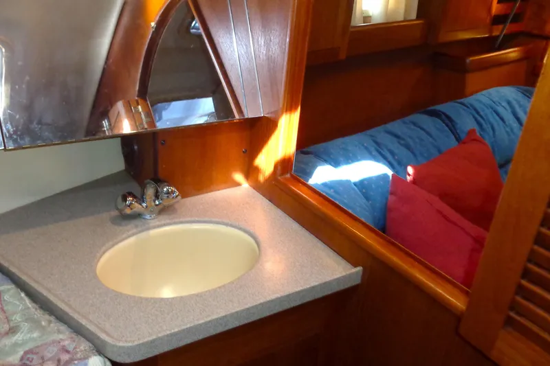 Slide: The Image of Interior of 2001 Hunter 380 yacht with blue seating and wooden accents. - 10