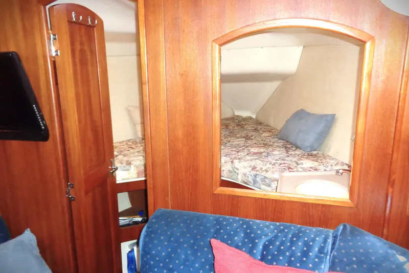 Slide: The Image of Cozy cabin bed in 2001 Hunter 380 sailboat with floral bedding and wooden interior. - 11