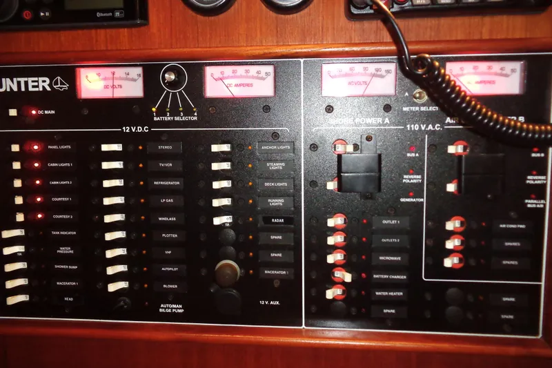 Slide: The Image of Interior of 2001 Hunter 380 sailboat with wooden cabinetry and seating area. - 13