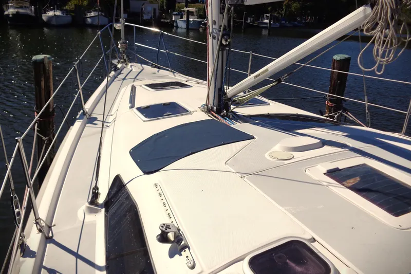 Slide: The Image of Deck view of a 2001 Hunter 380 sailboat docked in a marina. - 23