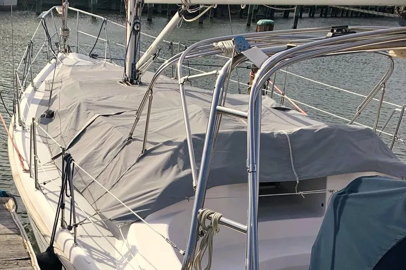Slide: The Image of Covered 2001 Hunter 380 sailboat docked at marina. - 24
