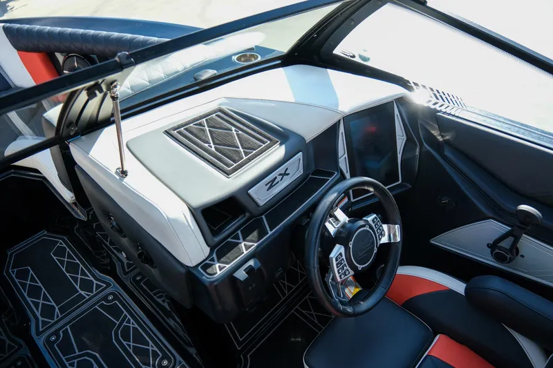 Slide: The Image of 2021 Tigé 21ZX boat interior with modern dashboard and steering wheel design. - 14